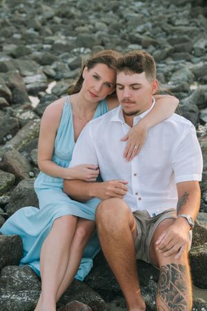 Coastal engagement photography session in the Golden Isles sitting on rocks