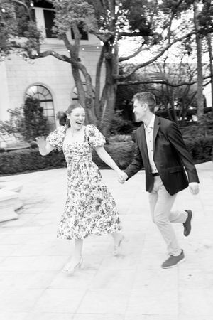 Documentary image of a couple running on Sea Island GA during proposal and engagement photography session in south georgia