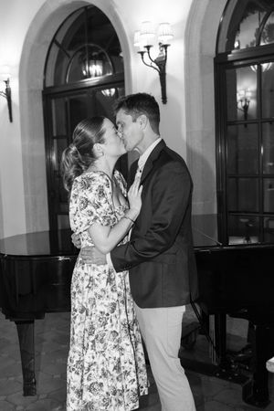 couple embracing by the piano at the Cloister Inn at Sea Island Resort during surprise engagement