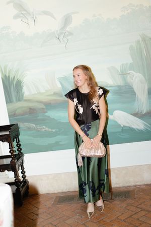 Newly financed bride-to-be smiles in front of iconic painting in the sitting room of the Cloister at the Sea Island Resort during a proposal