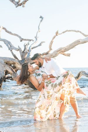 Engagement photography session on driftwood beach during sunrise photo session