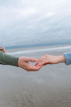 Ring and hand shot of newly engaged couple during surprise proposal on Jekyll Island near St. Simons Island