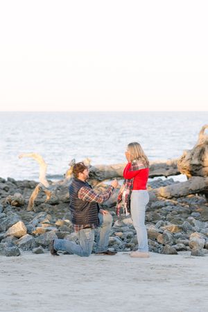Proposal surpriseon the beach in winter, driftwood beach engagement in the winter, christmas time engagement jekyll island georgia
