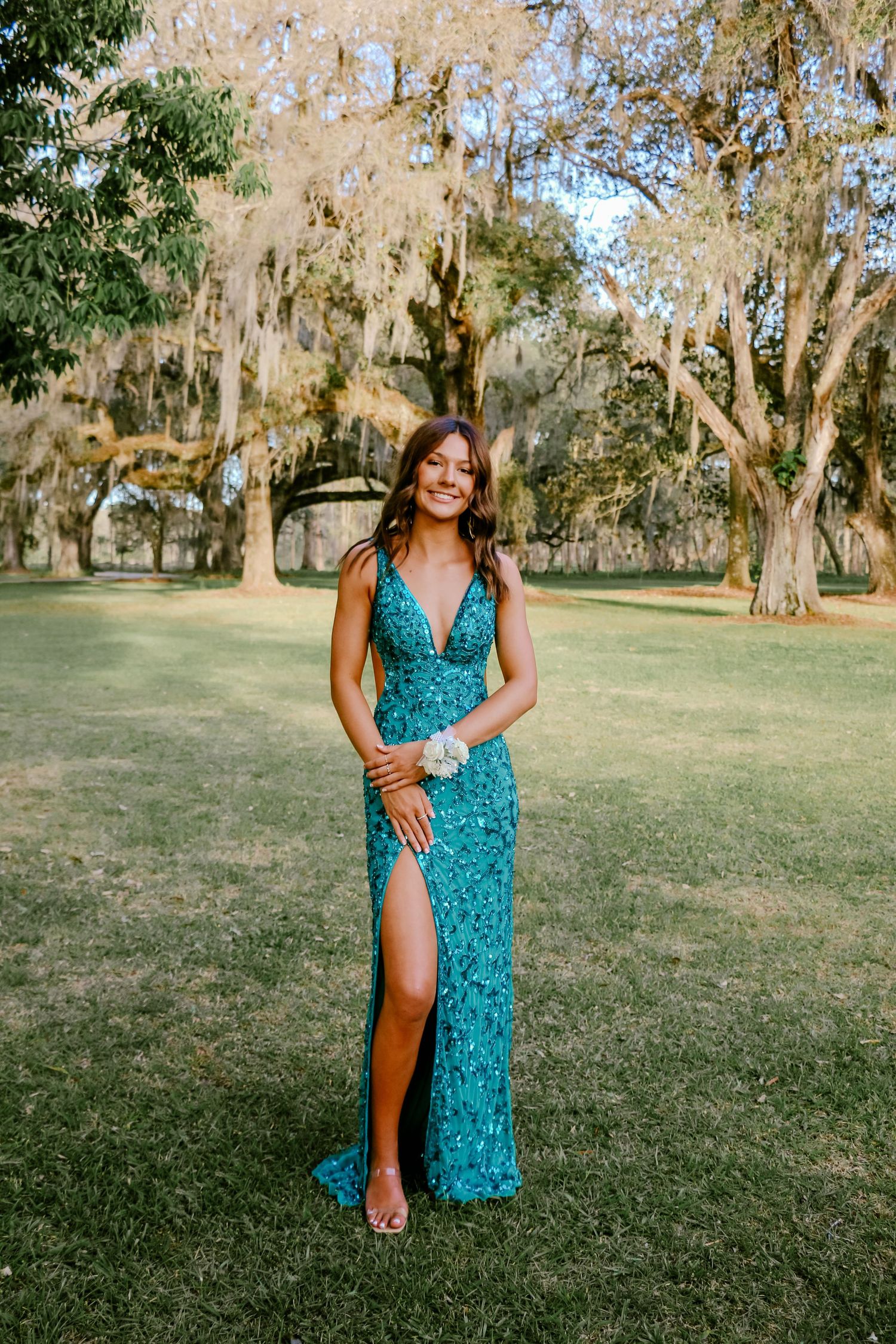 A formal event in a Southern garden setting with Spanish moss hanging from old oak trees.