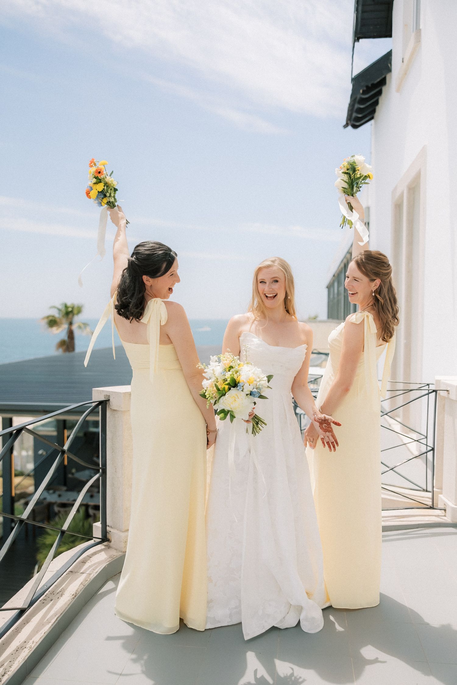 Joyful first look between the bride and her bridesmaids before a seaside destination wedding in Portugal, photographed by a Portugal wedding