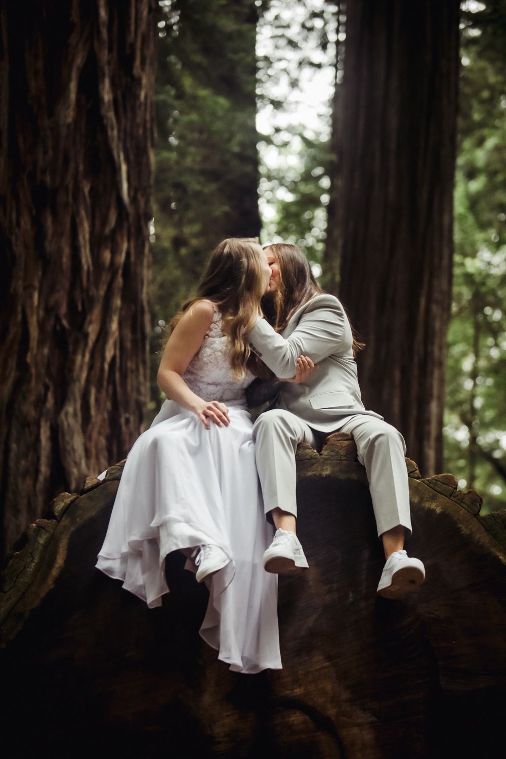 Couples kissing on the trail in the California redwoods on their wedding day.