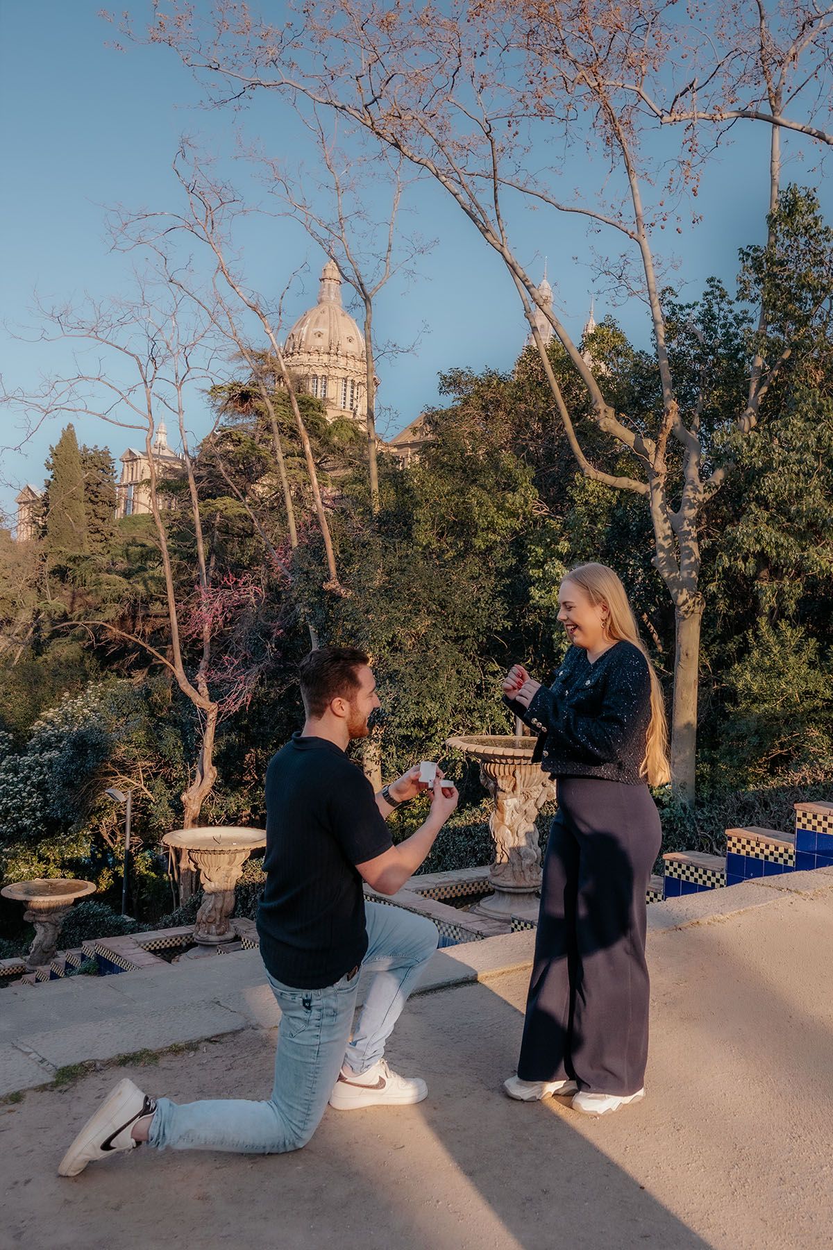 Romantic engagement session at dusk featuring the illuminated water cascades of Montjuic.