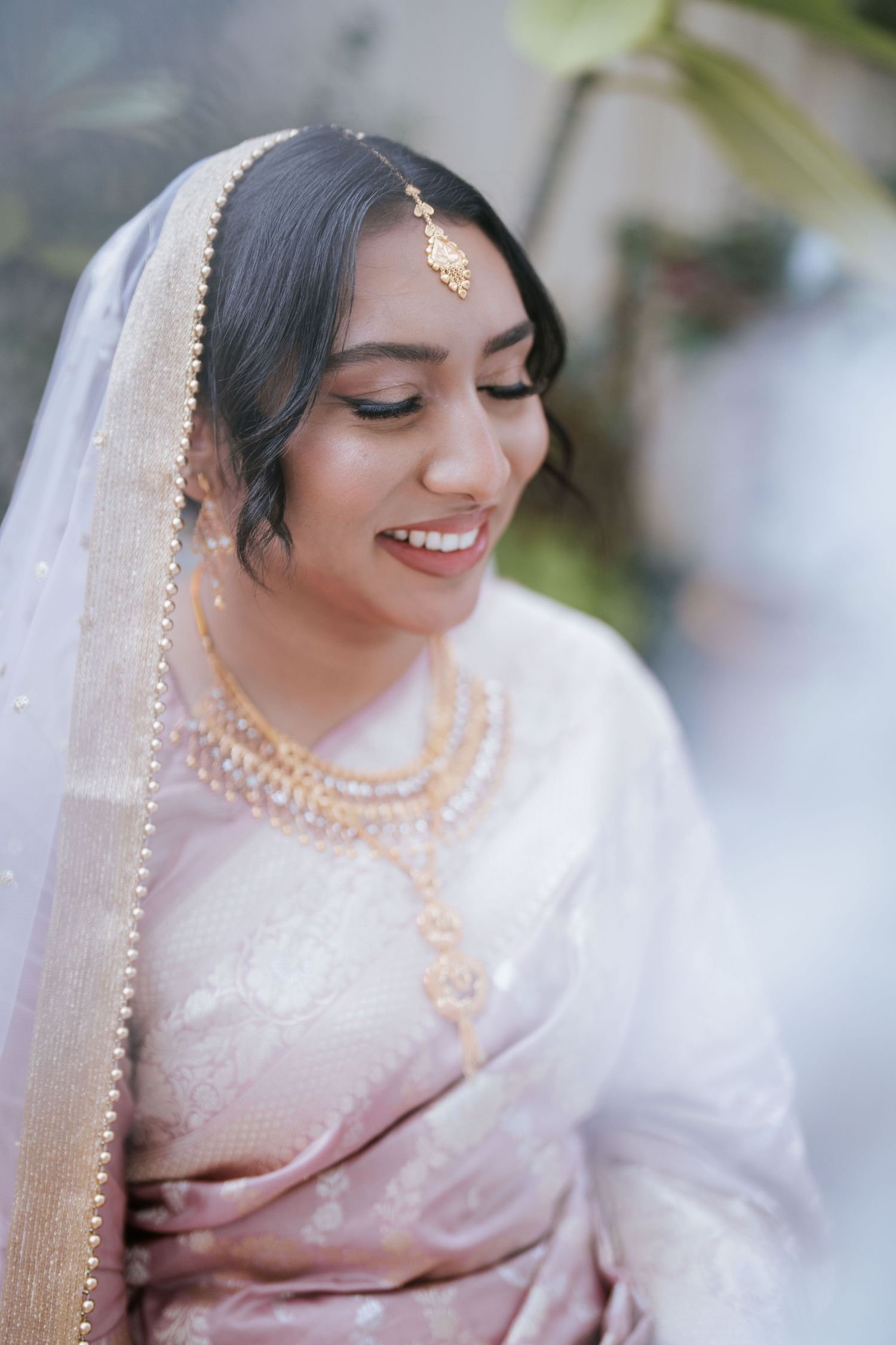 Bride in pink saree smiling during her Nikah ceremony in Sydney