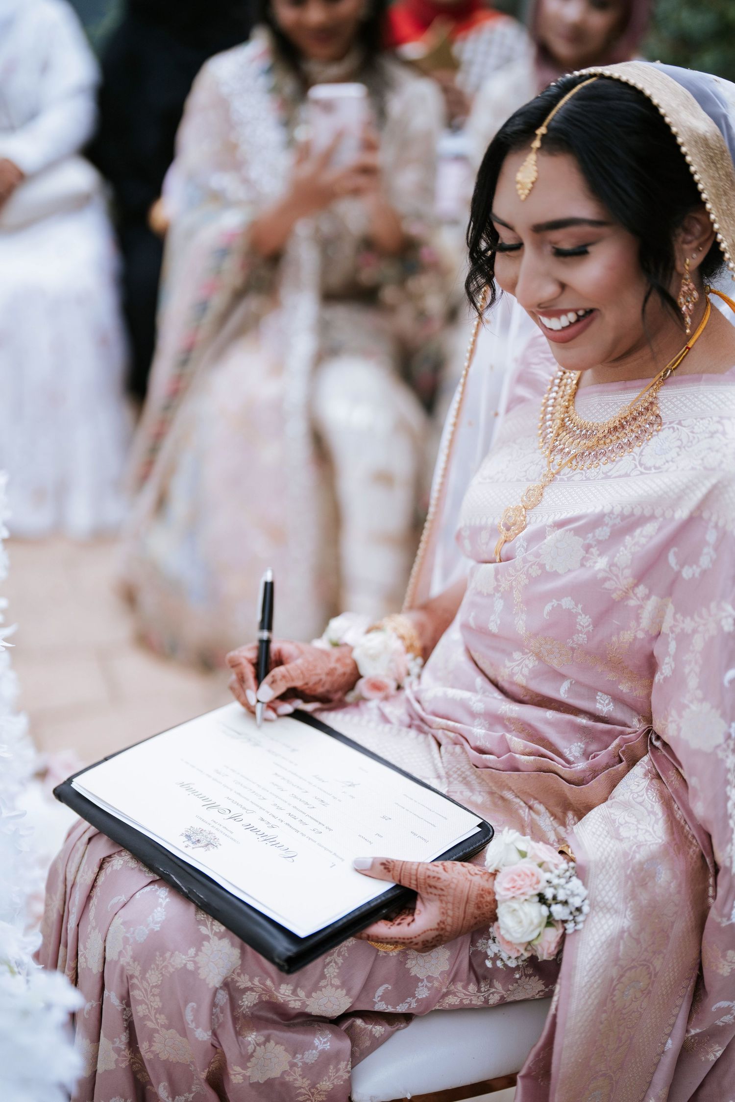 Bride signing the Nikah marriage certificate - Sydney Muslim wedding photography