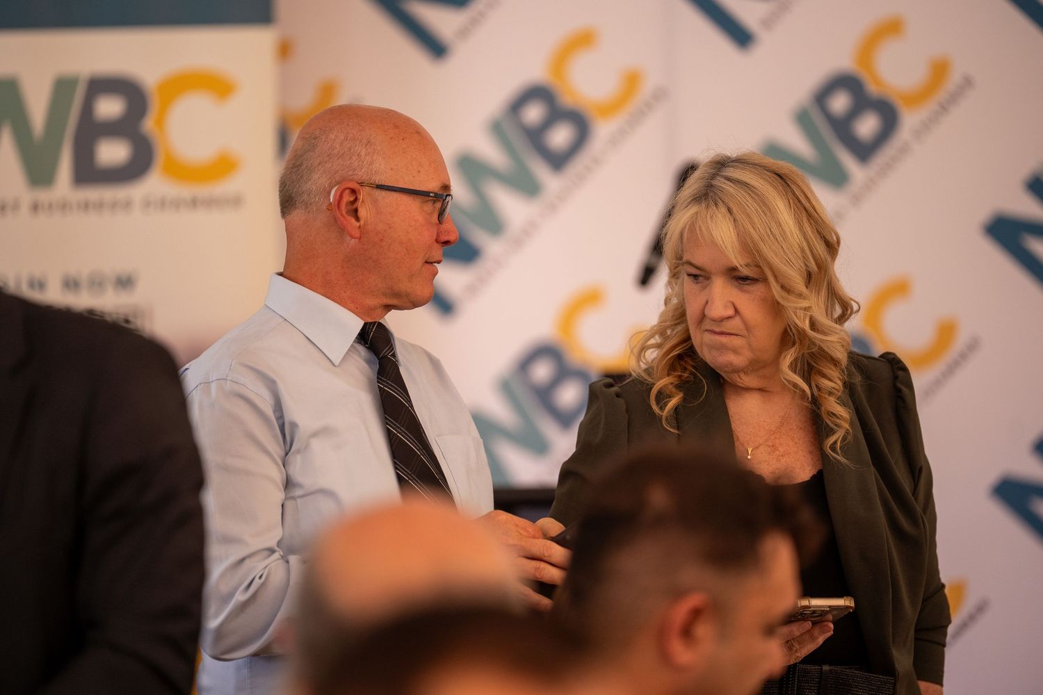 Man and woman engaged in conversation at NWBC business chamber networking event.