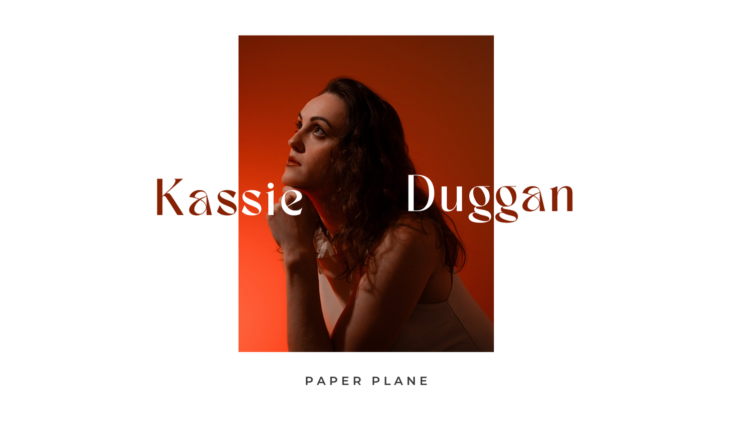 Kassie Duggan Paper Plane album cover featuring artist in warm red-orange lighting with elegant serif typography.