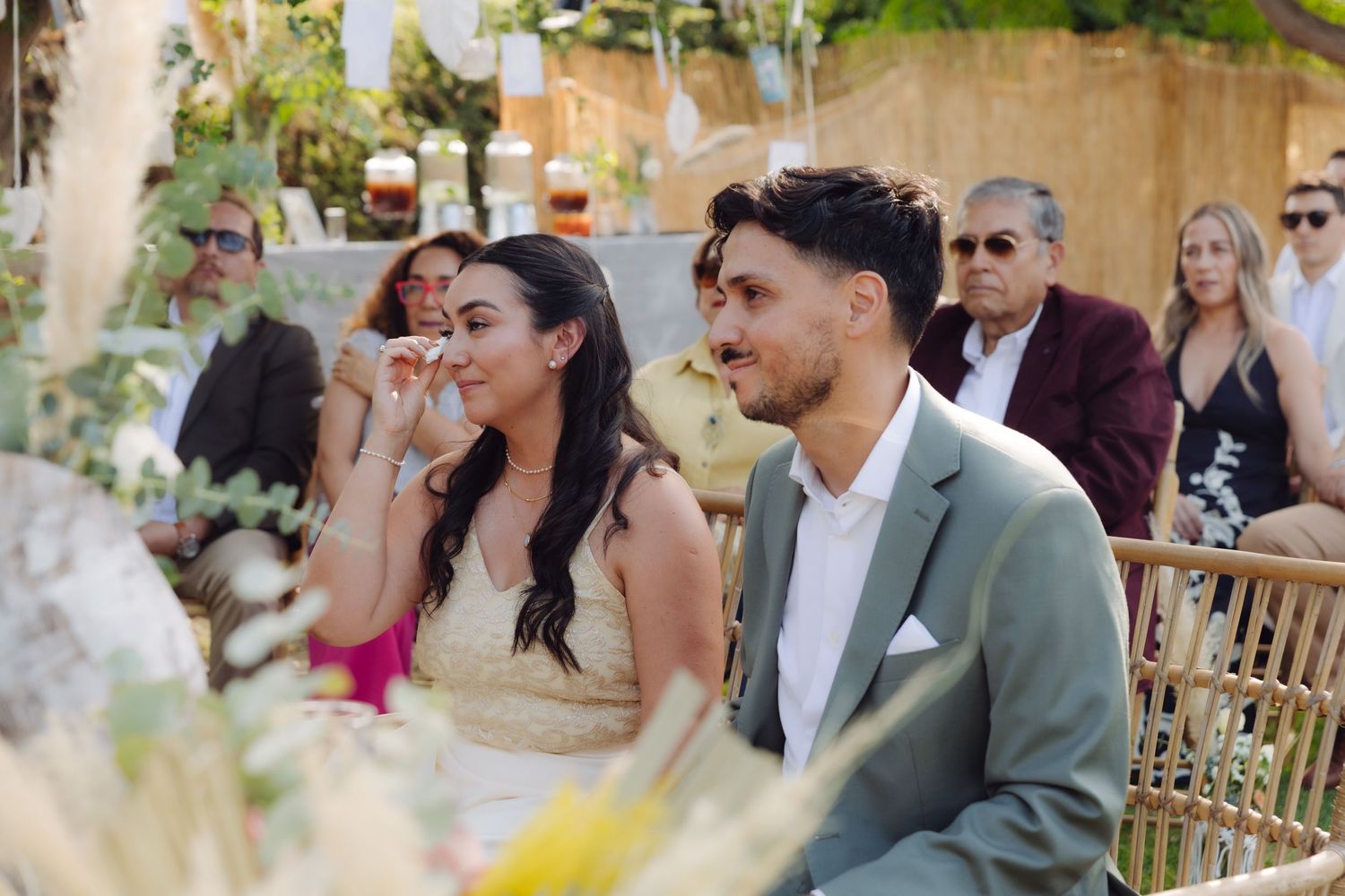 Bride and groom sharing an emotional moment during their outdoor garden wedding ceremony.