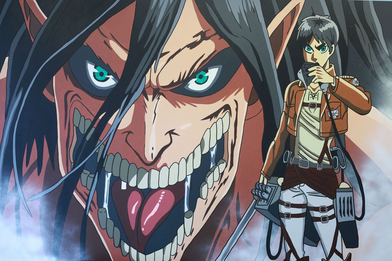 Attack on Titan anime poster featuring Eren Yeager's titan form with glowing eyes beside Mikasa Ackerman in Survey Corps gear.