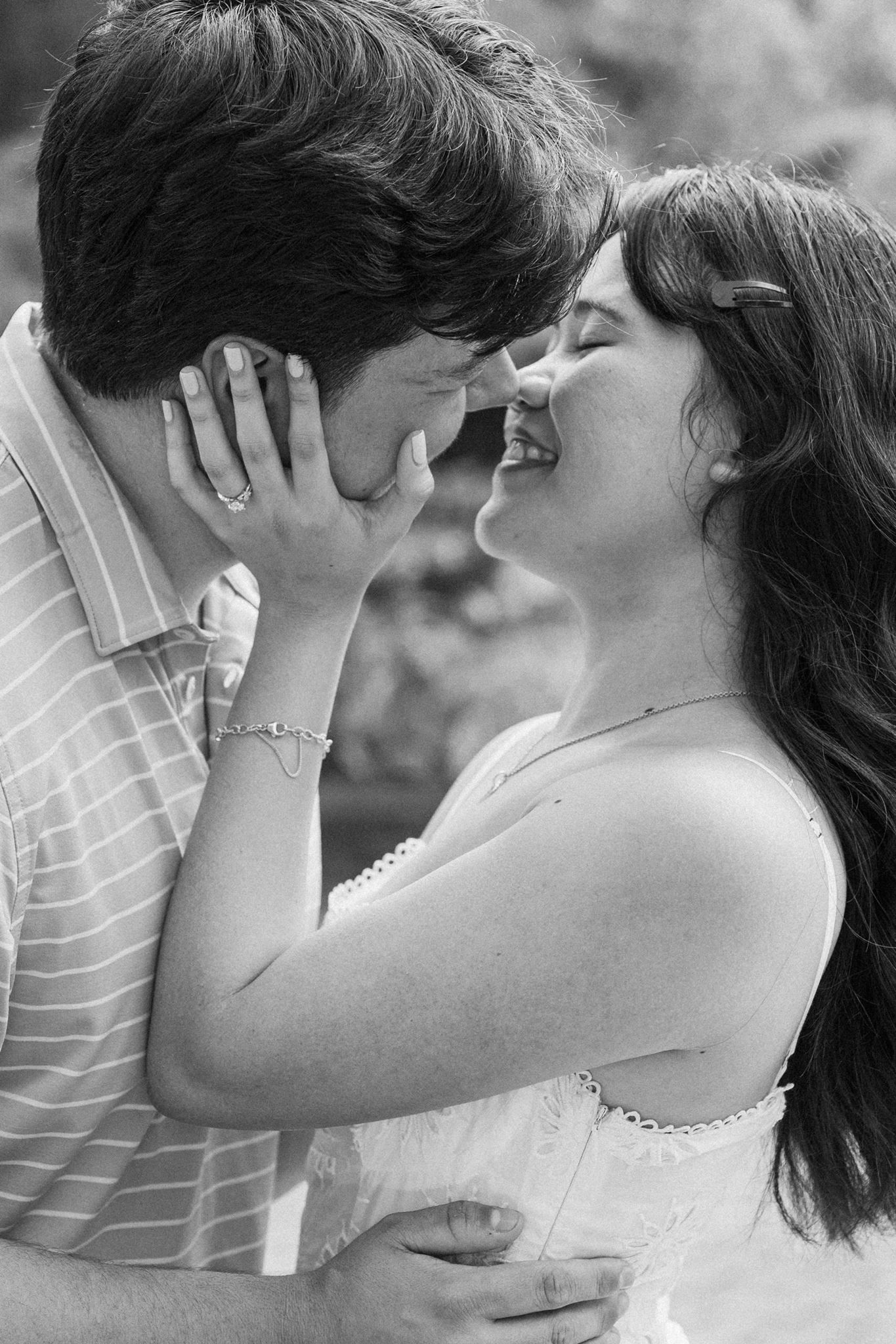 A couple shares a romantic kiss during proposal at Mercer Botanic Garden in Spring Tx