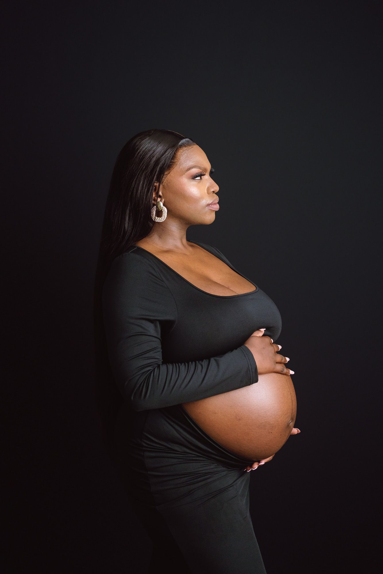 Maternity couple surrounded by beautiful forest scenery during their pregnancy photoshoot