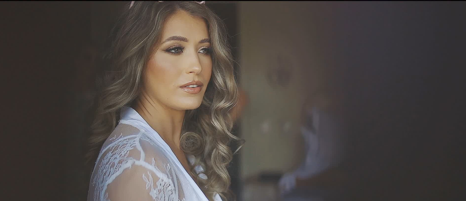 Natural bridal portrait captured in soft window light on the wedding morning.