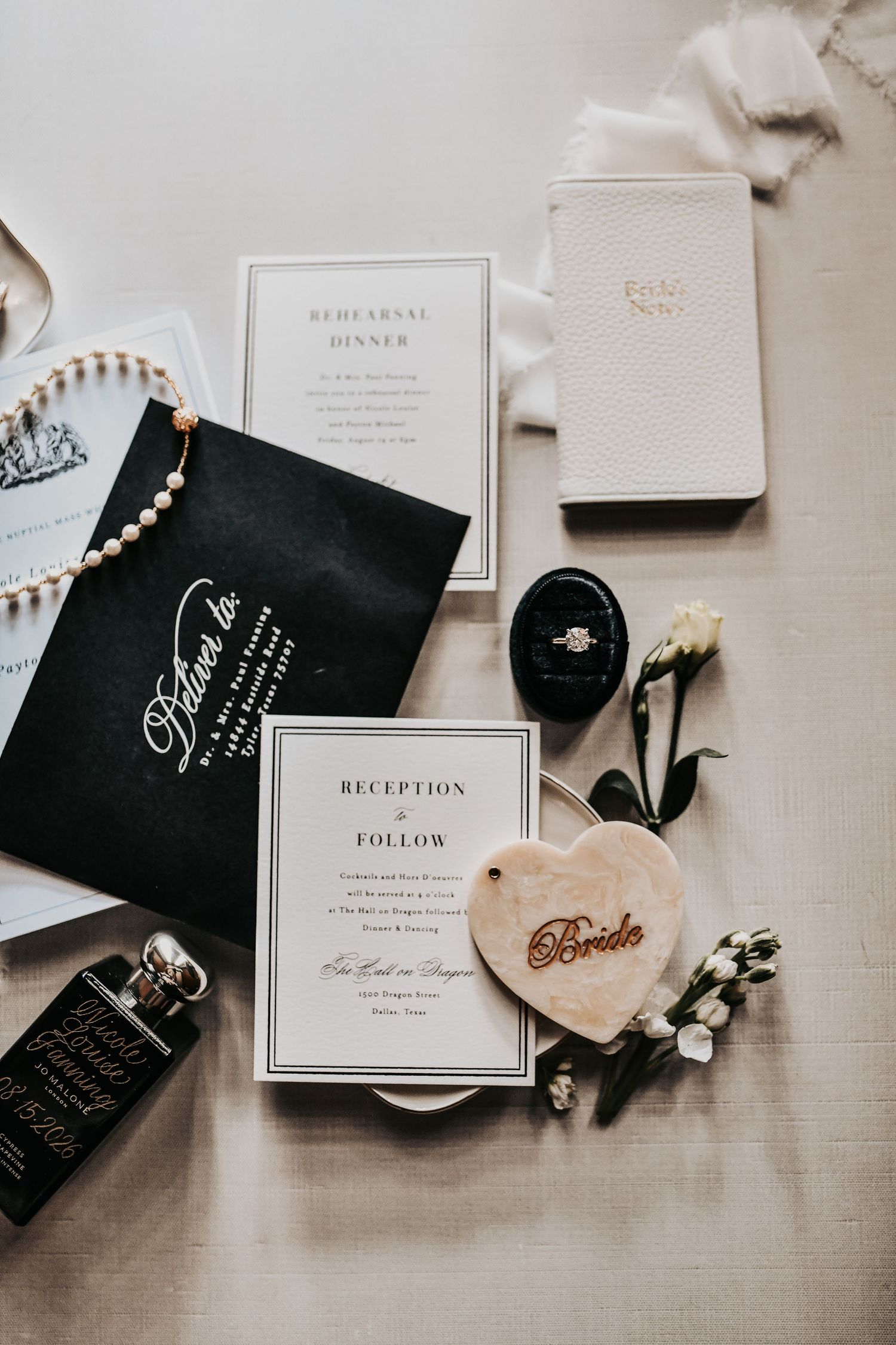 Nicole and Payton’s wedding rings styled with elegant black and gold details