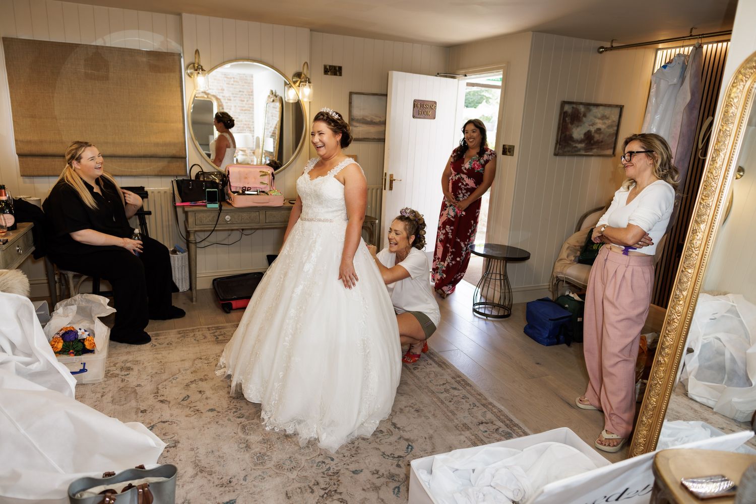 A bride and groom walk hand-in-hand through an elegant stone courtyard of a historic building.