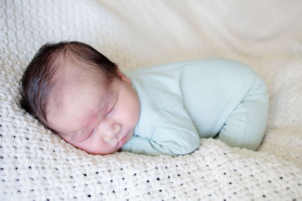 Baby boy posed at home during a newborn lifestyle session in Oak Ridge, TN with Nina Thomas Photography.