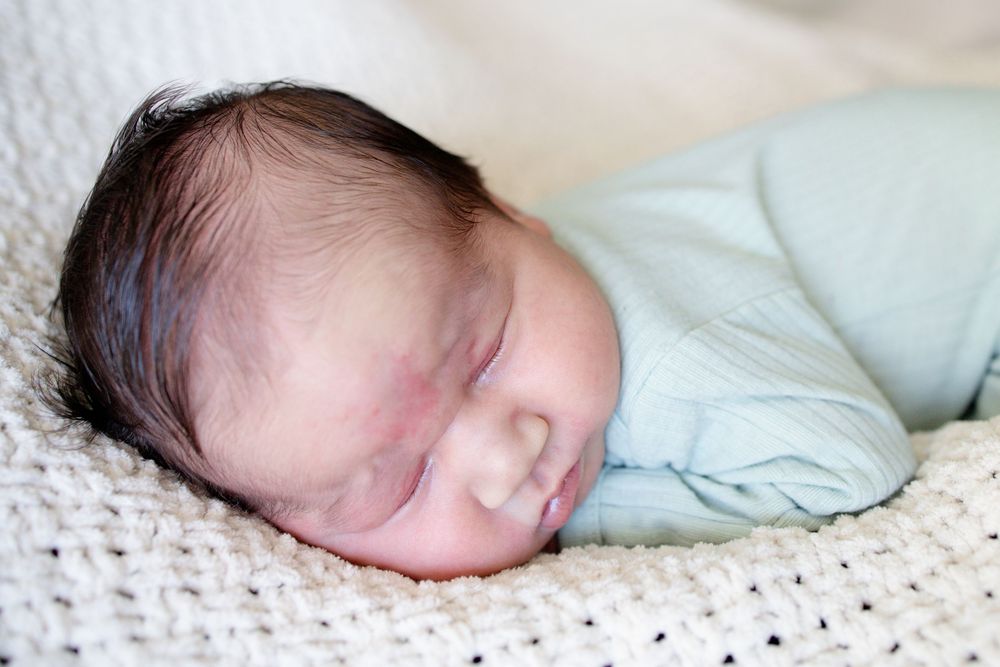 Sweet baby boy posed at home during a newborn lifestyle session in Oak Ridge, TN with Nina Thomas Photography.