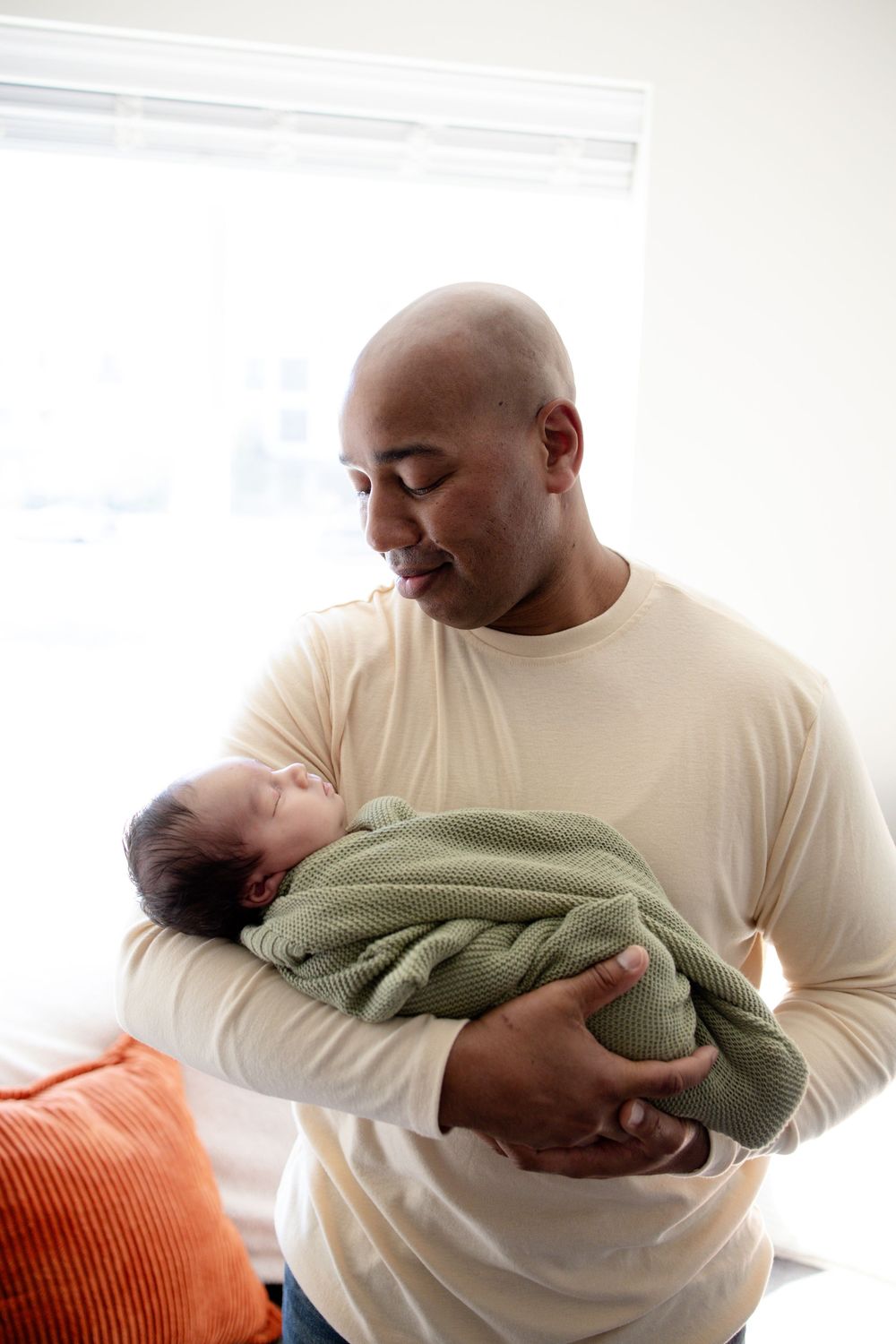 A smiling father and baby boy during a newborn lifestyle session in Oak Ridge, TN with Nina Thomas Photography.