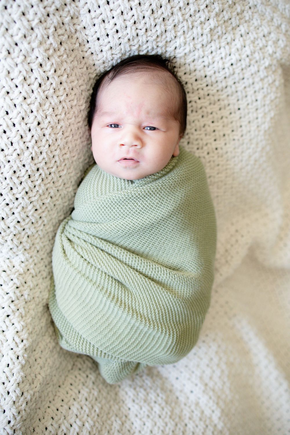 Newborn baby swaddled during a newborn lifestyle session in Oak Ridge, TN with Nina Thomas Photography.