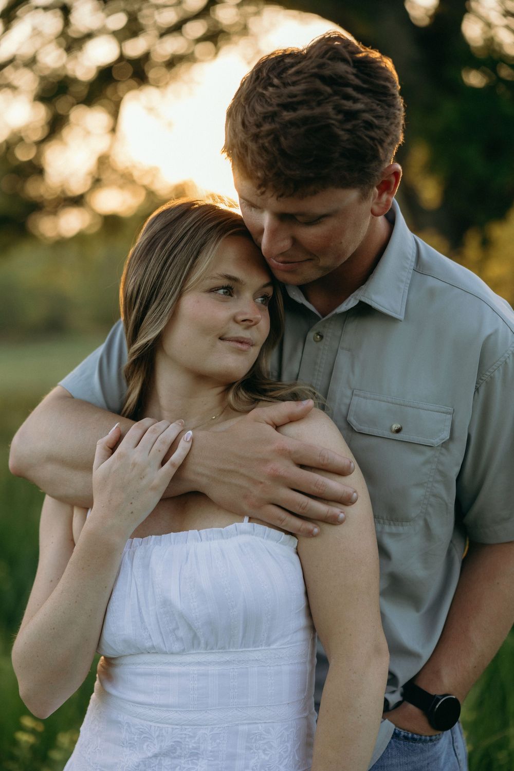 A couple posing for Georgia wedding photographer during their engagement session in the open fields south of Atlanta.