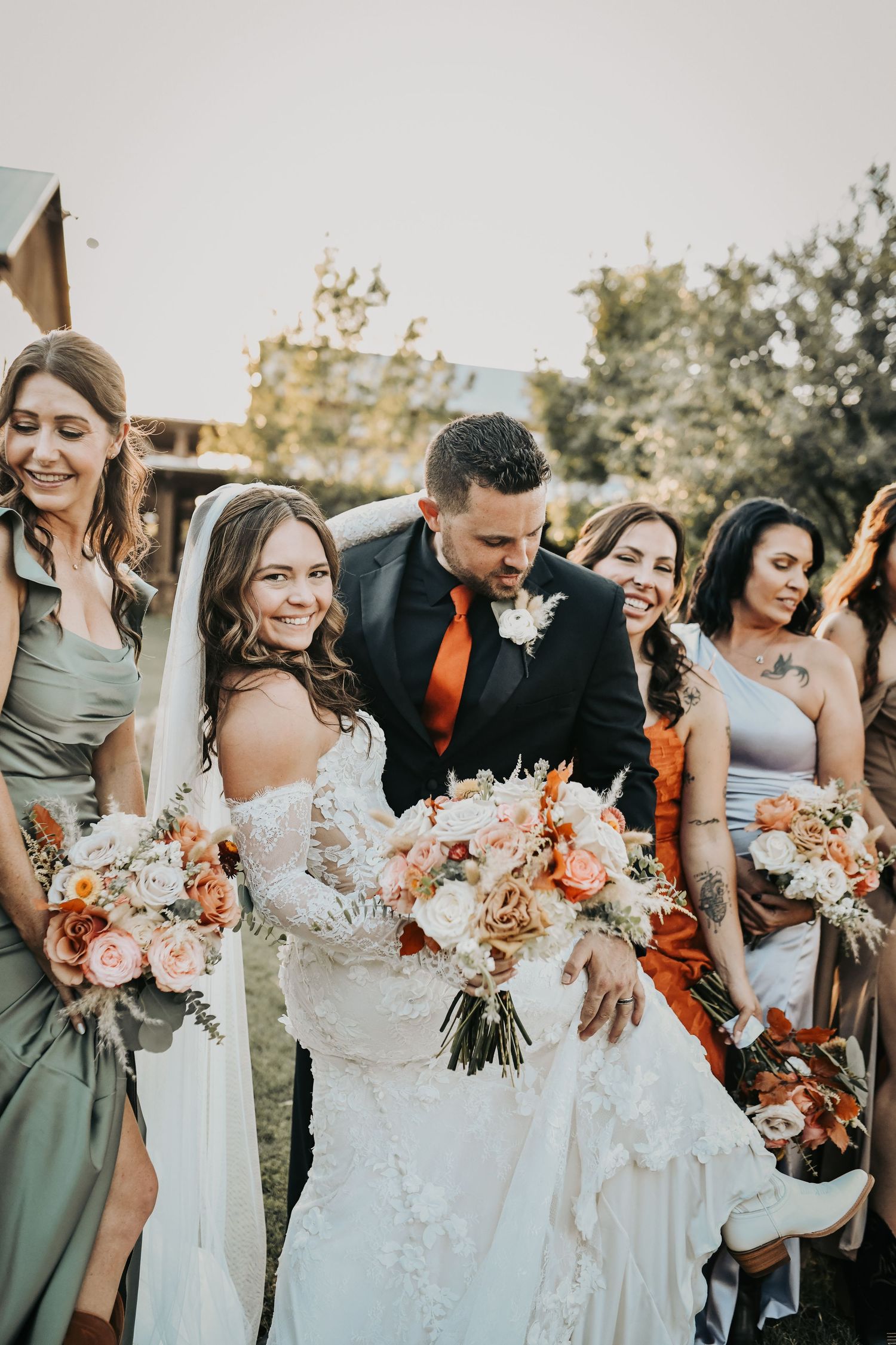 Bride and groom sharing a fun wedding day moment with ranch donkeys