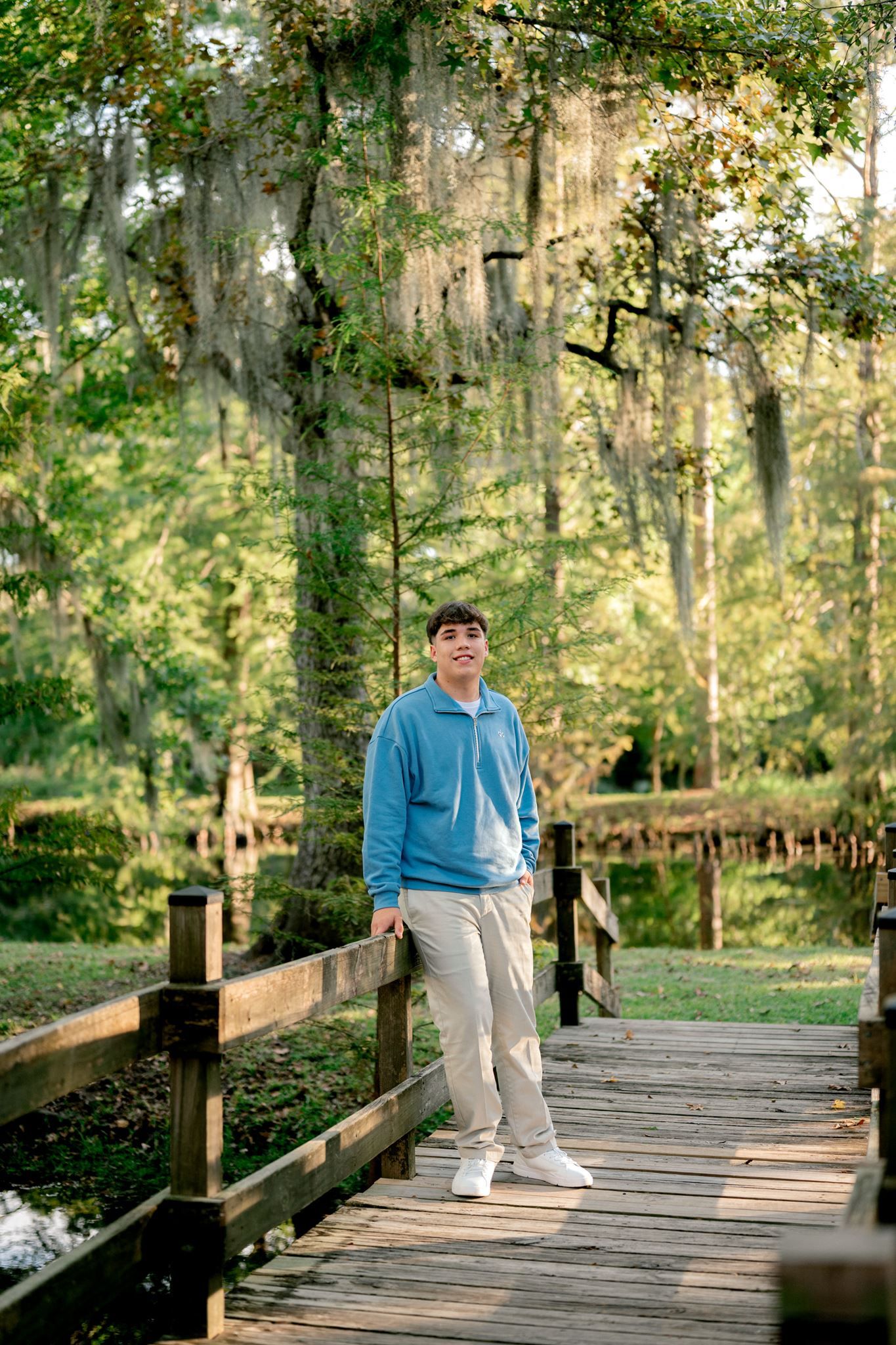 High school senior portraits under a mossy tree.