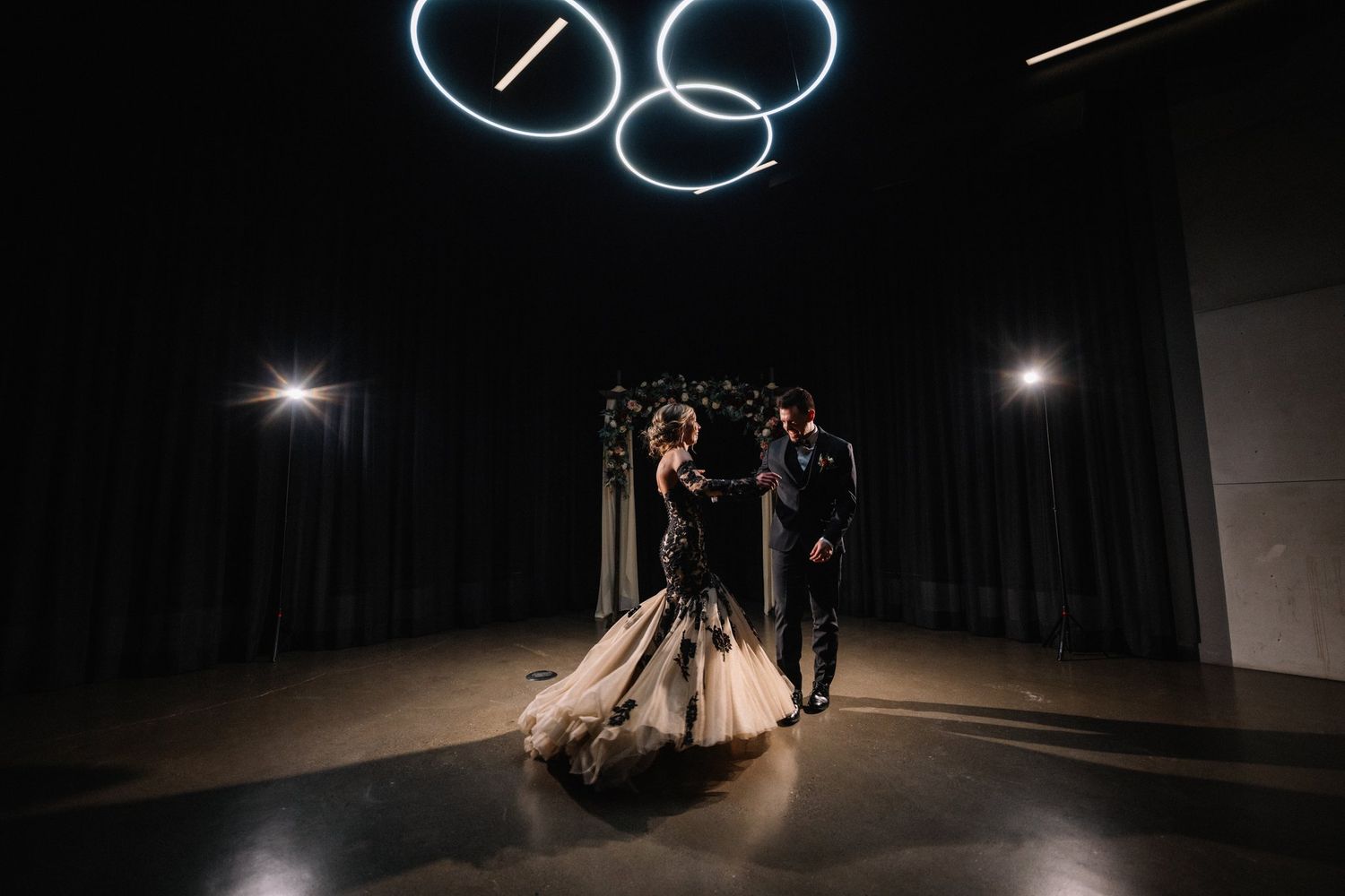 First dance under glowing ring lights on a dark dance floor at Mainspace in Canmore
