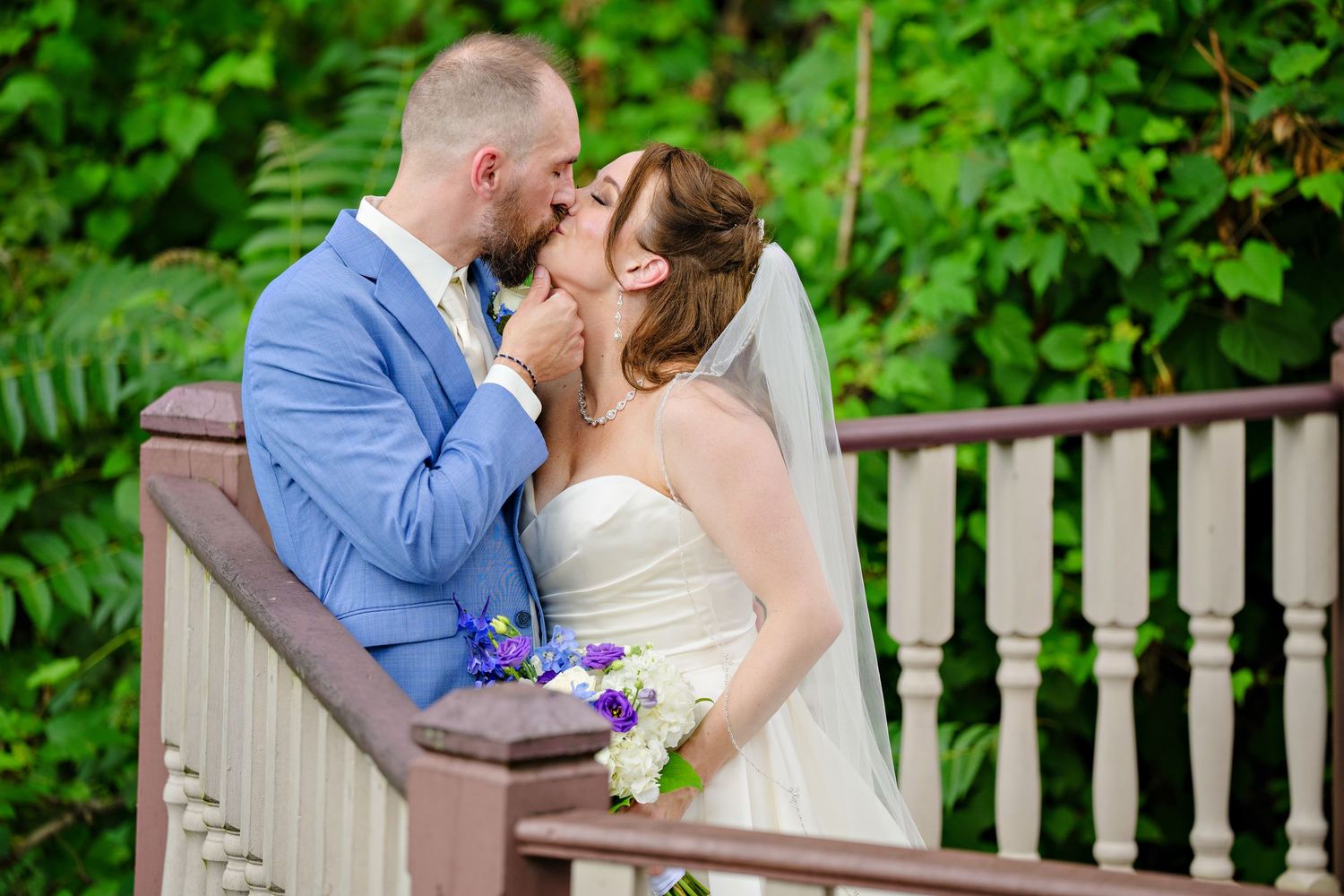 Bride and Groom kissing on an overlook at Grand Pacific Junction after their wedding at Grand Pacific Gardens in Olmsted Falls, Ohio