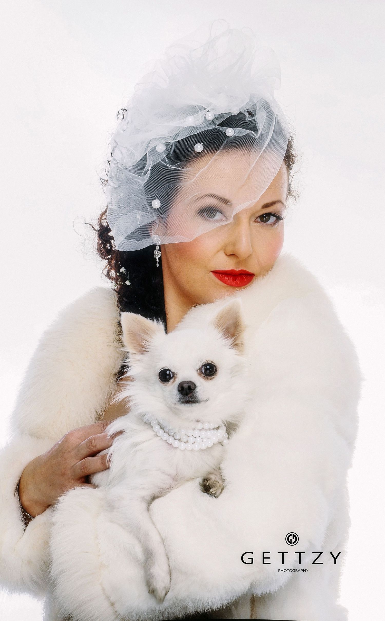 Vintage-inspired portrait with white Chihuahua, fur stole, and tulle headpiece.