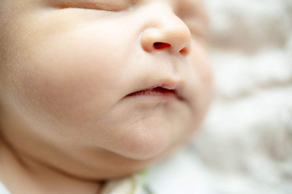 Close-up of a newborn baby's face with soft skin and delicate features fresh 48 newborn photography at University of Tennessee.