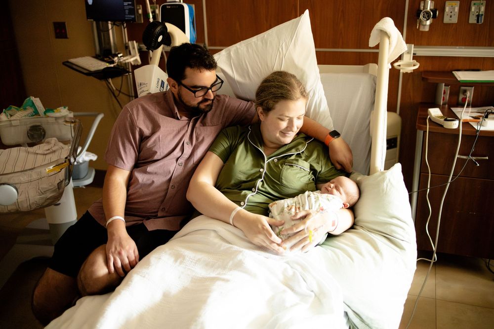 New parents admire their newborn baby fresh 48 newborn photography at University of Tennessee Medical Center in Knoxville, Tennessee.