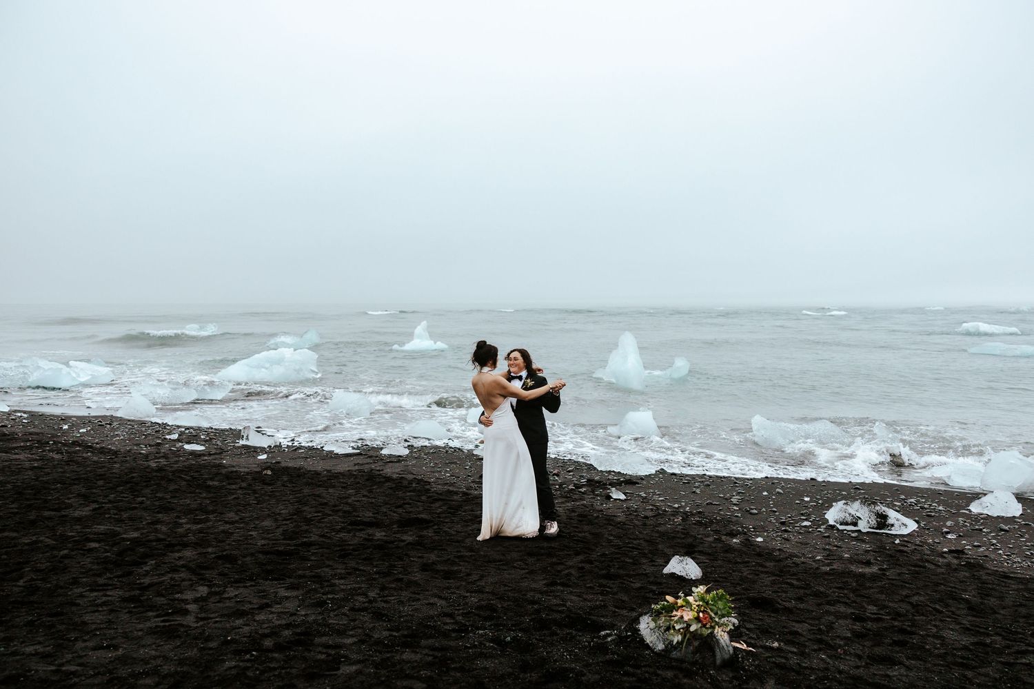 brides having a first dance at Diamond Beach, Iceland during elopement