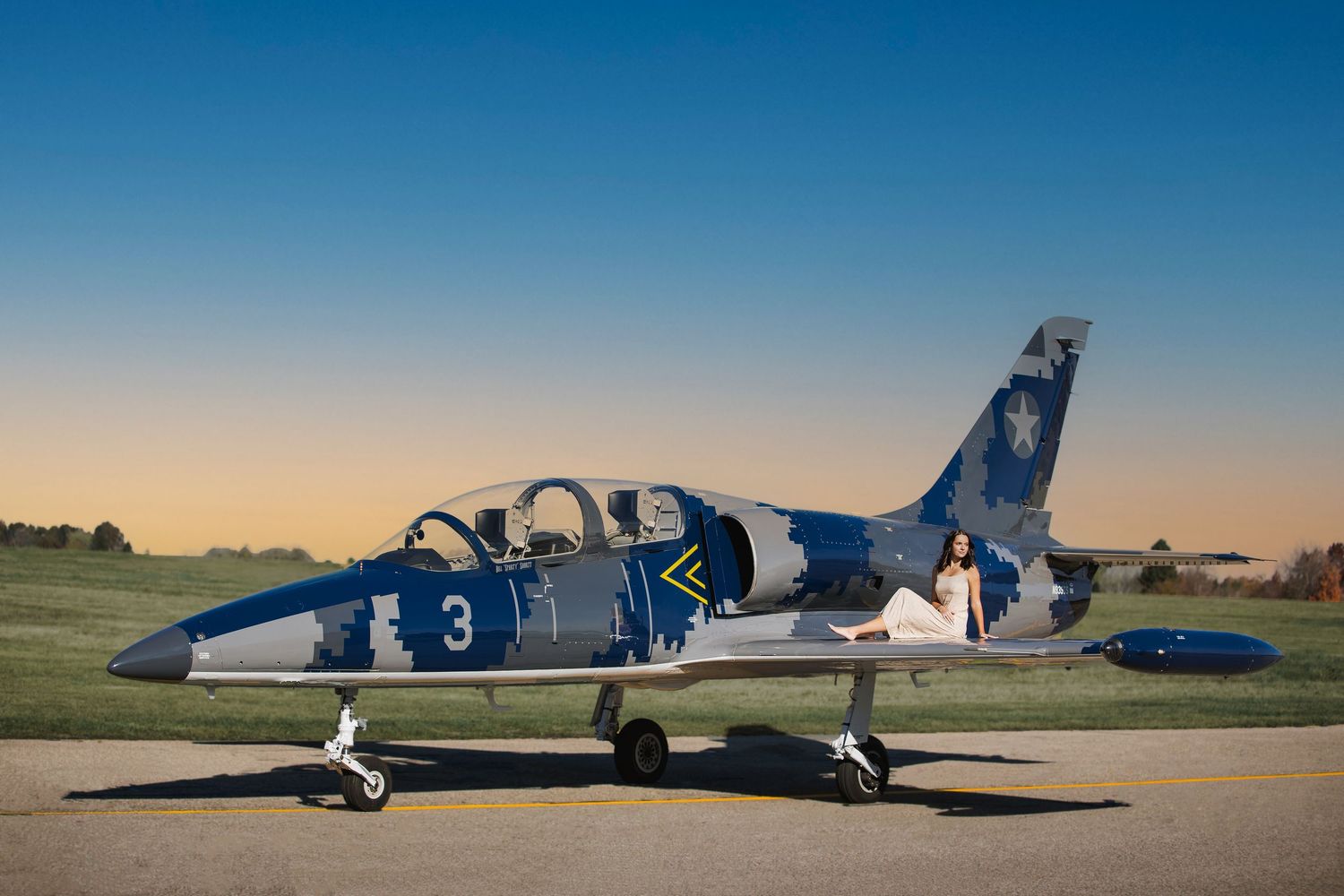 Creative high school senior photo for future pilot with cinematic aviation theme and private jet in Howell, MI by Brighton photographer