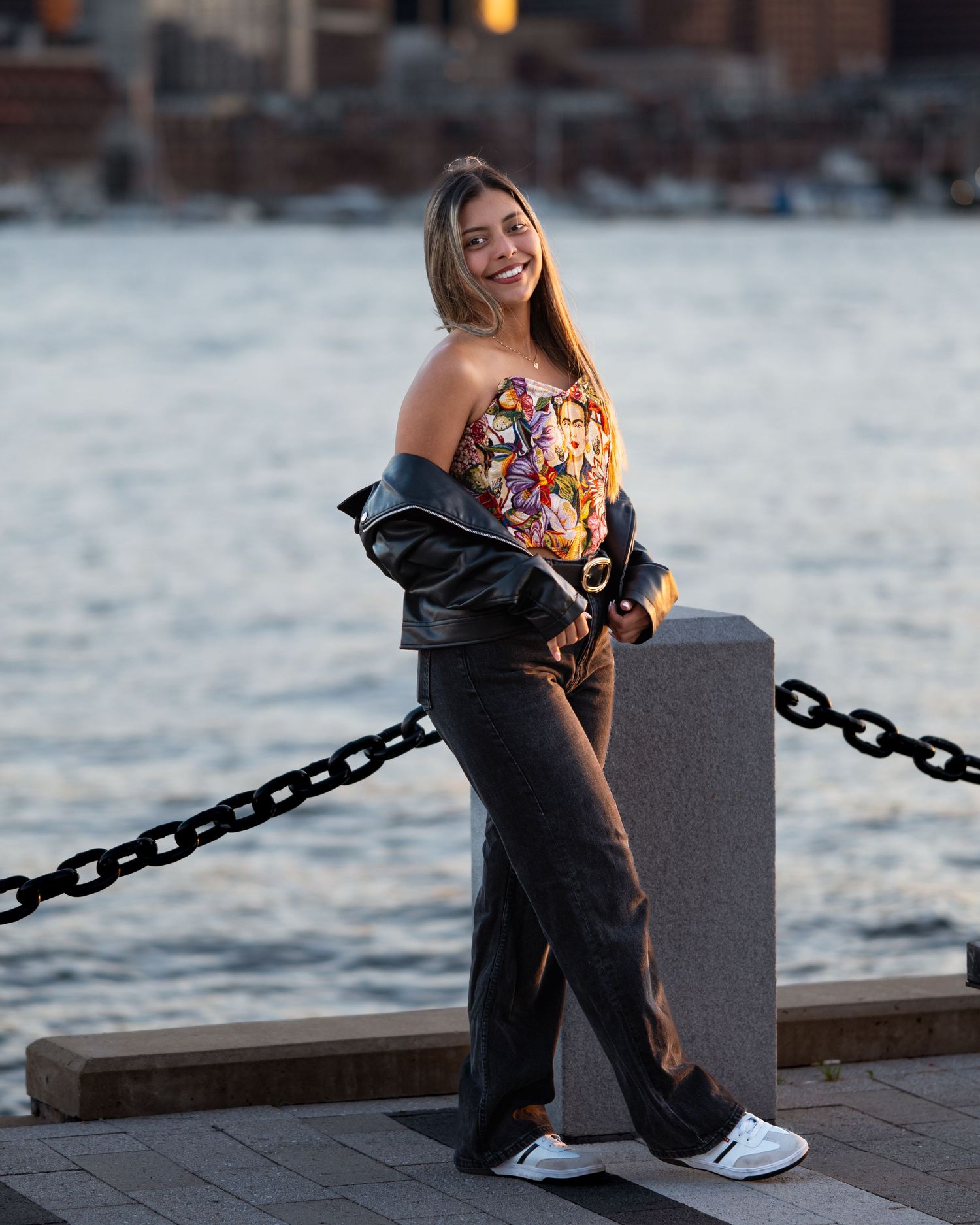 Owner and designer of SWAGGA NOW, poses in her Frida Khalo corset for one of her brand collections with Boston cityscape in the background.