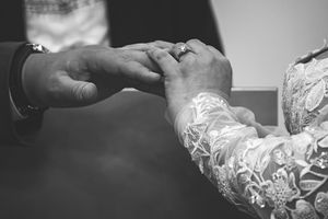 A black and white series of hands creating lace or delicate textile work in a traditional crafting process.