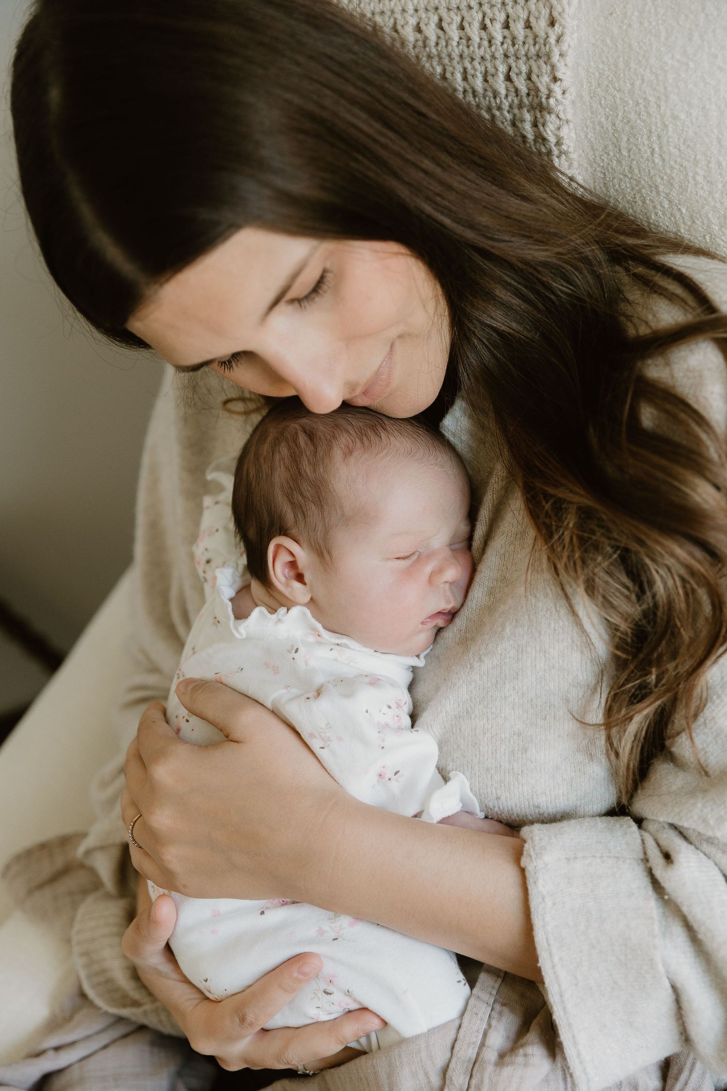Beautiful newborn snuggles with mom during an in-home newborn session in East Texas