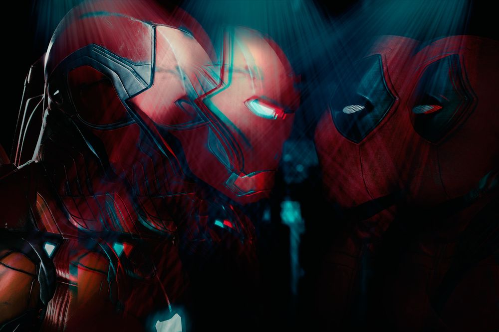 Dark artistic rendering of Iron Man and Spider-Man helmets with glowing blue accents against a black background.