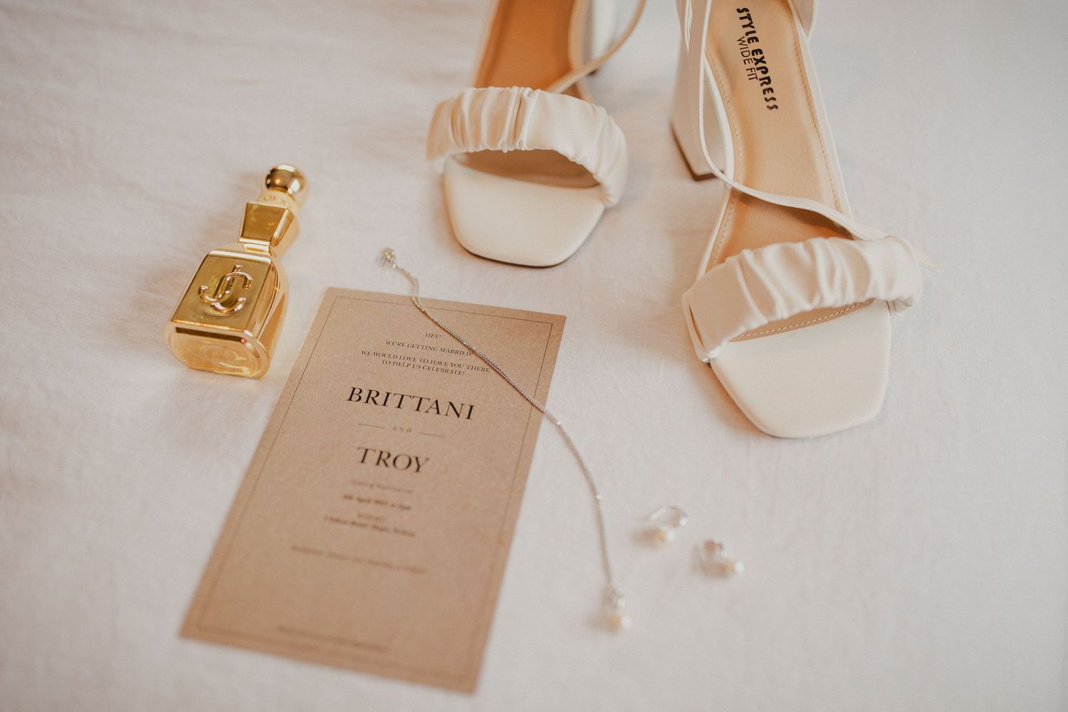 Brides shoes, perfume + jewellery. Wedding getting ready moment.
