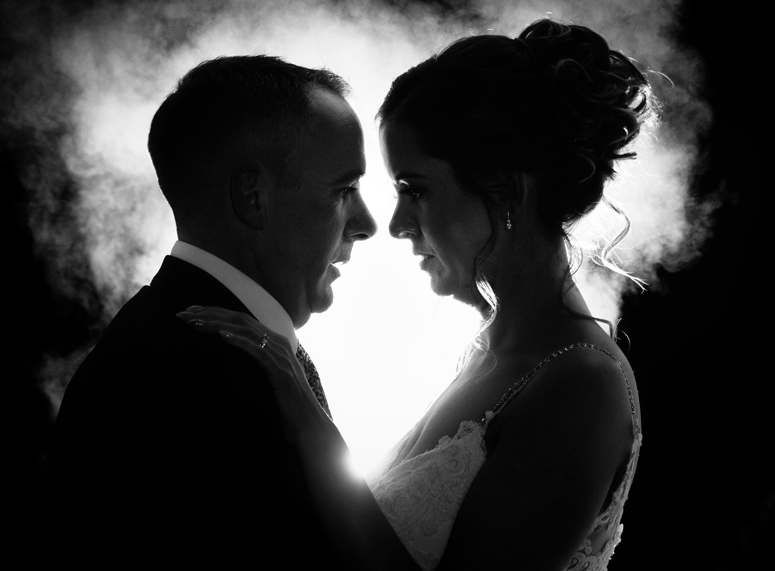 Dramatic backlit silhouette of wedding couple in black and white with misty background at Clanard Court Hotel Carlow