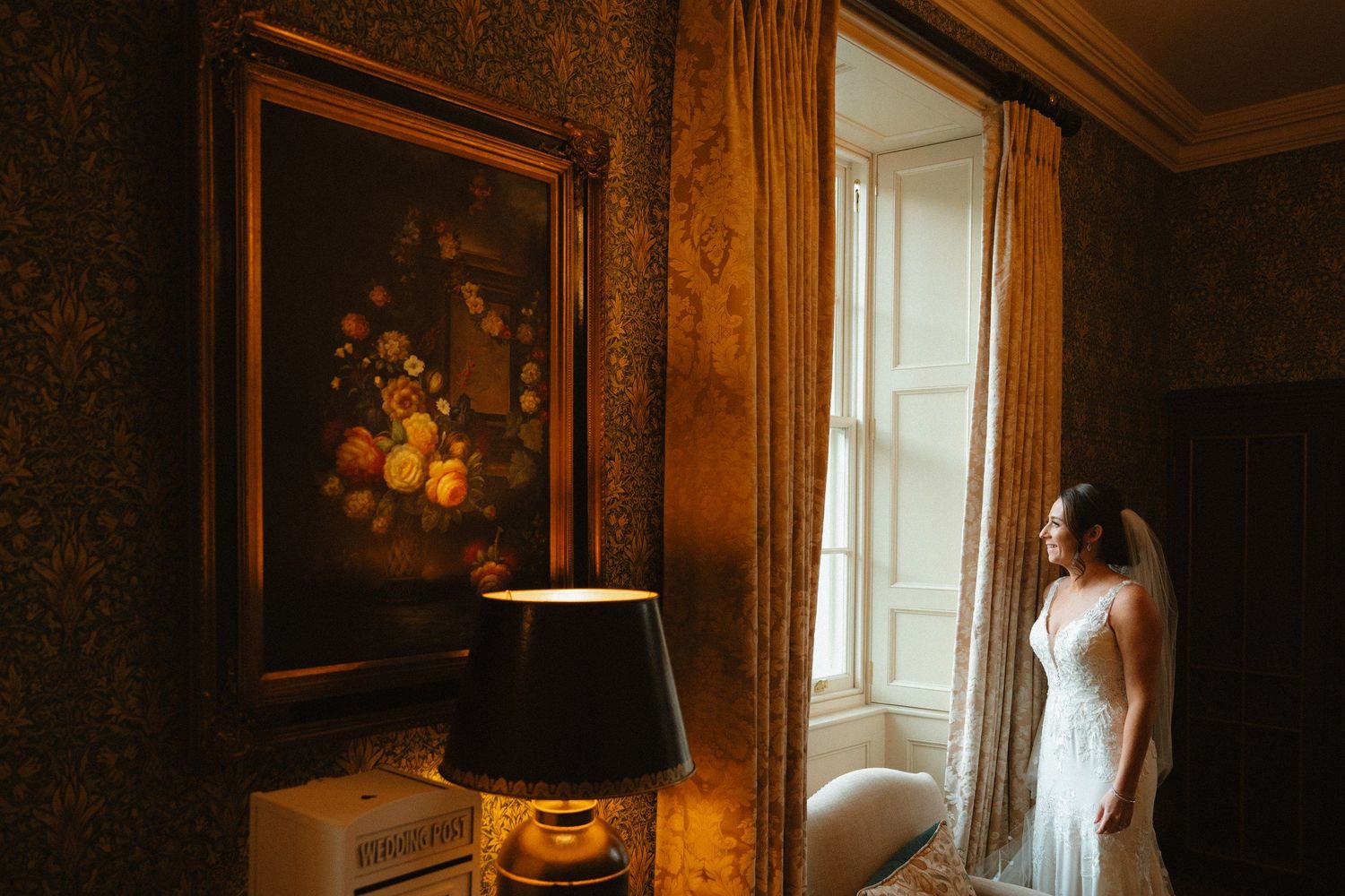 Bride beside a window in the richly decorated interior of Killeavy Castle.