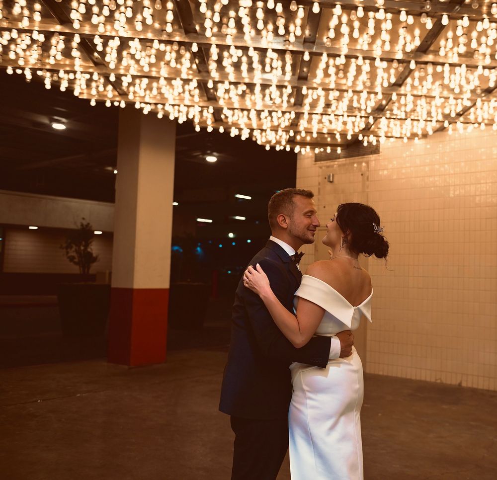 Newlyweds share a romantic first dance under sparkling string lights at their Las Vegas wedding reception.