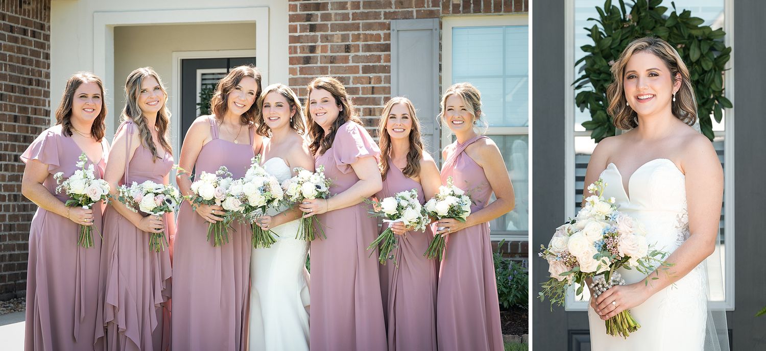 Bride in strapless gown poses with bridesmaids in dusty rose dresses holding white floral bouquets outdoors.