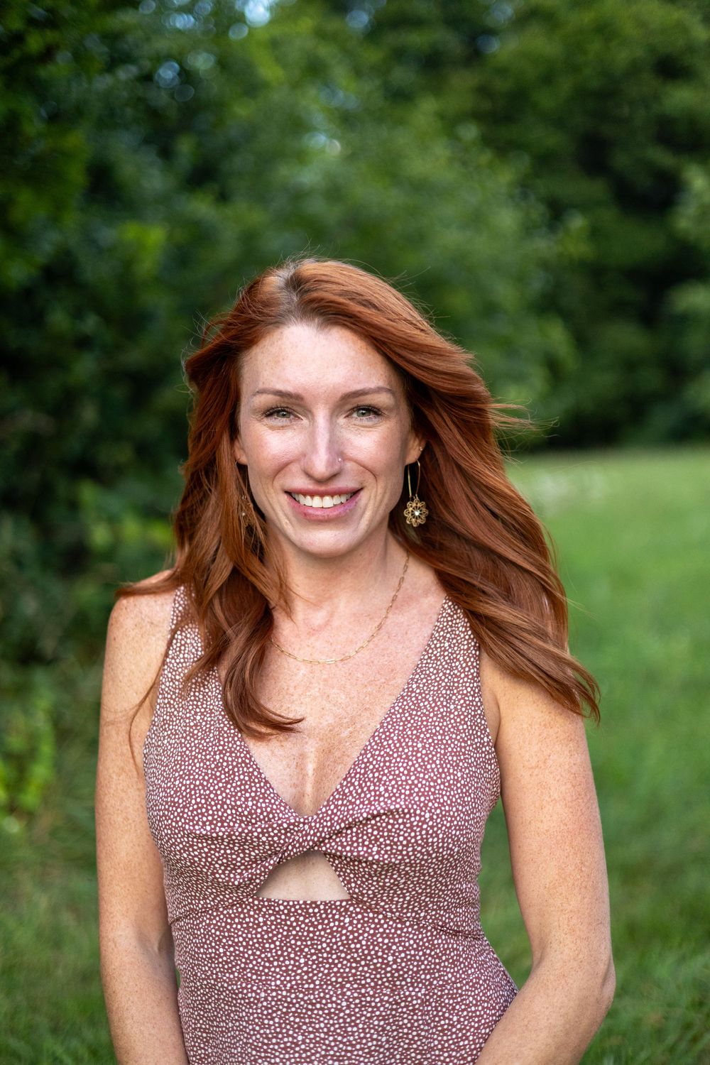 Women smiling for portrait in a field during golden hour