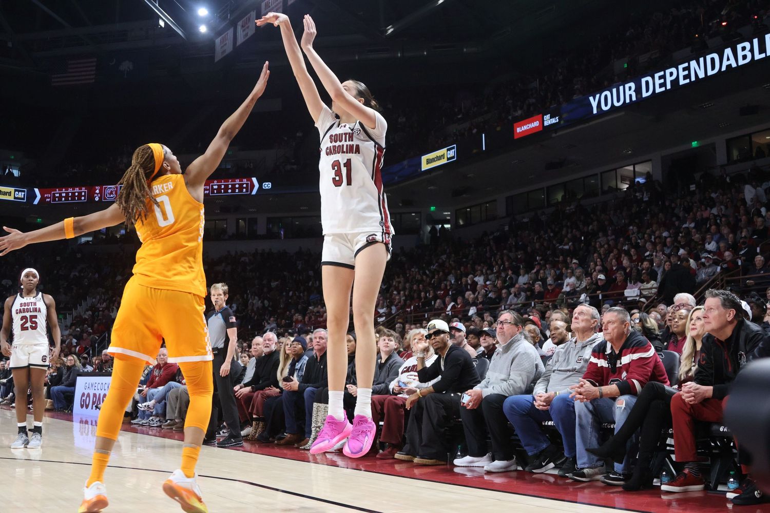 South Carolina basketball player wearing number 31 takes a jump shot over a Tennessee defender.