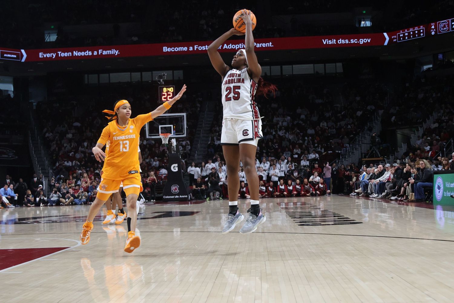 South Carolina basketball player wearing number 25 rises for a jump shot as a defender approaches.