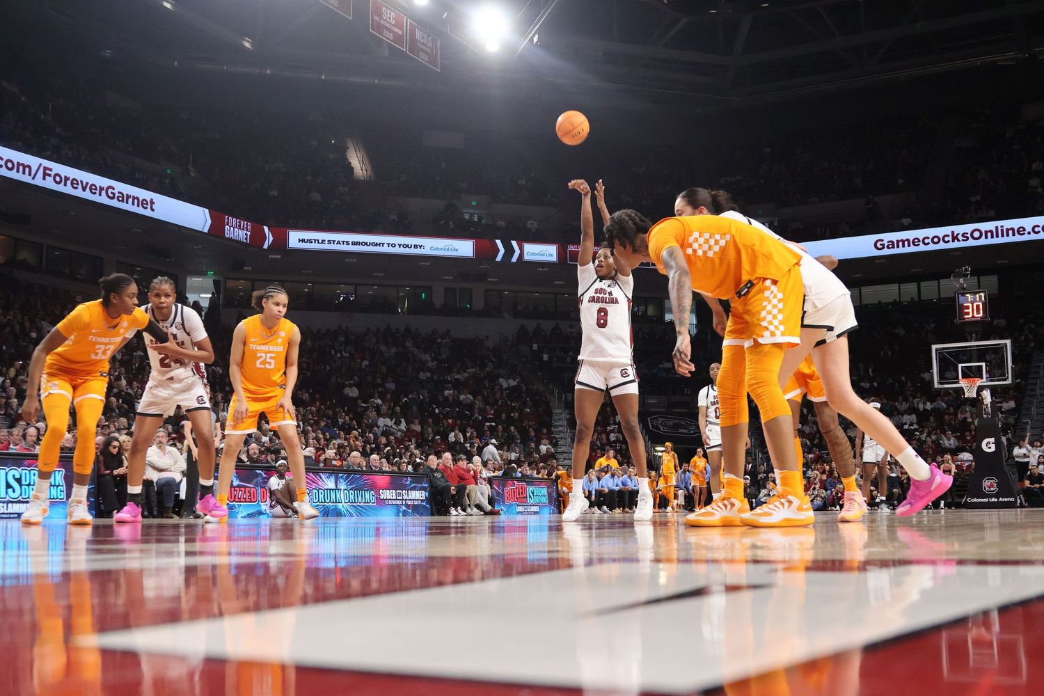 South Carolina basketball player shoots a free throw as Tennessee players line the lane.