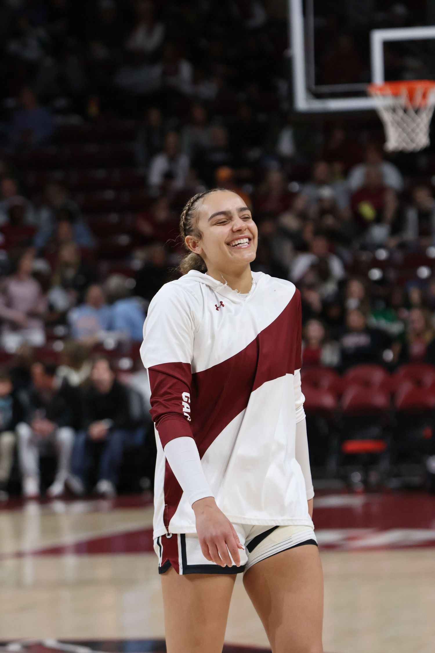 South Carolina basketball player smiles on the court during warmups.